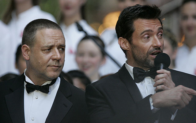 We're not sure what Hugh Jackman is saying here, but Russell Crowe looks entirely unimpressed. (Image: Eva Rinaldi/wikimedia)
